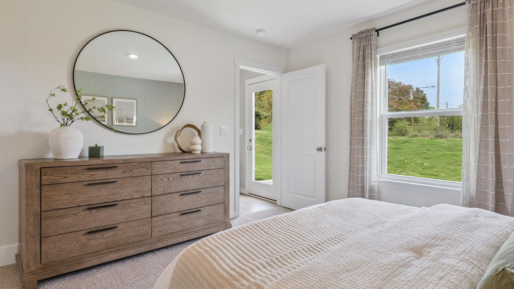 Primary bedroom with plush carpet floors and double light allowing windows