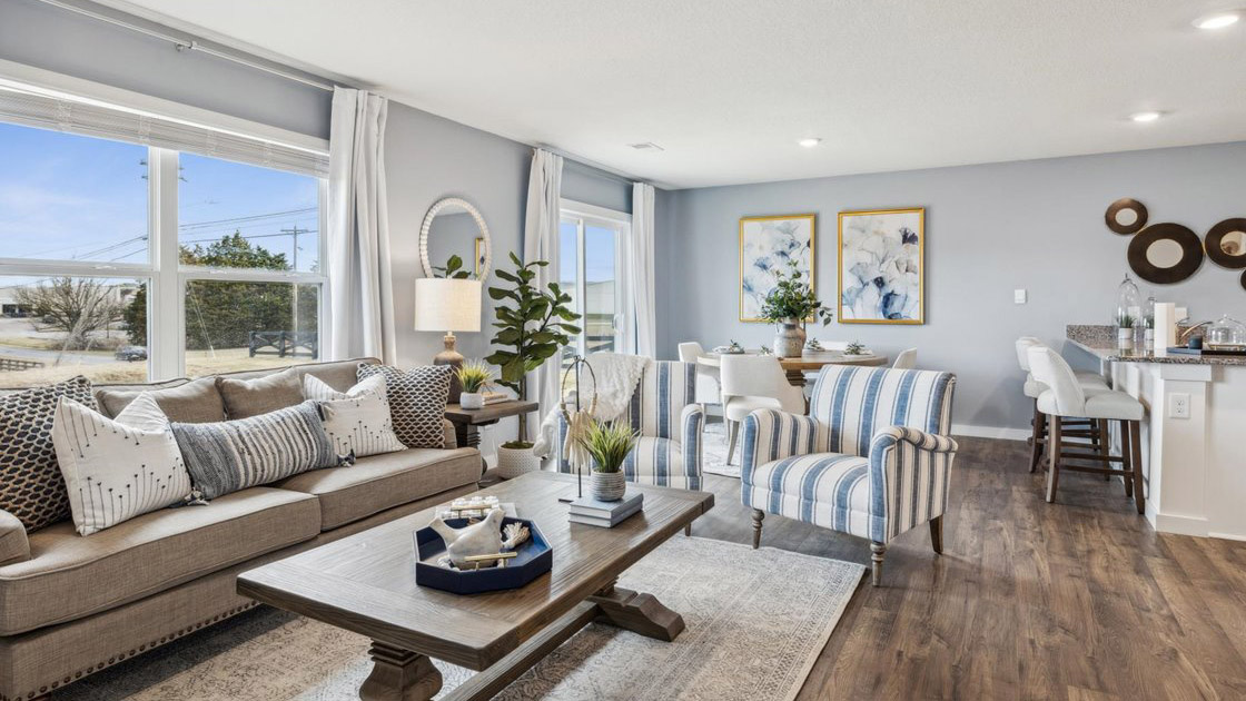 Spacious living and great  room space with light allowing windows