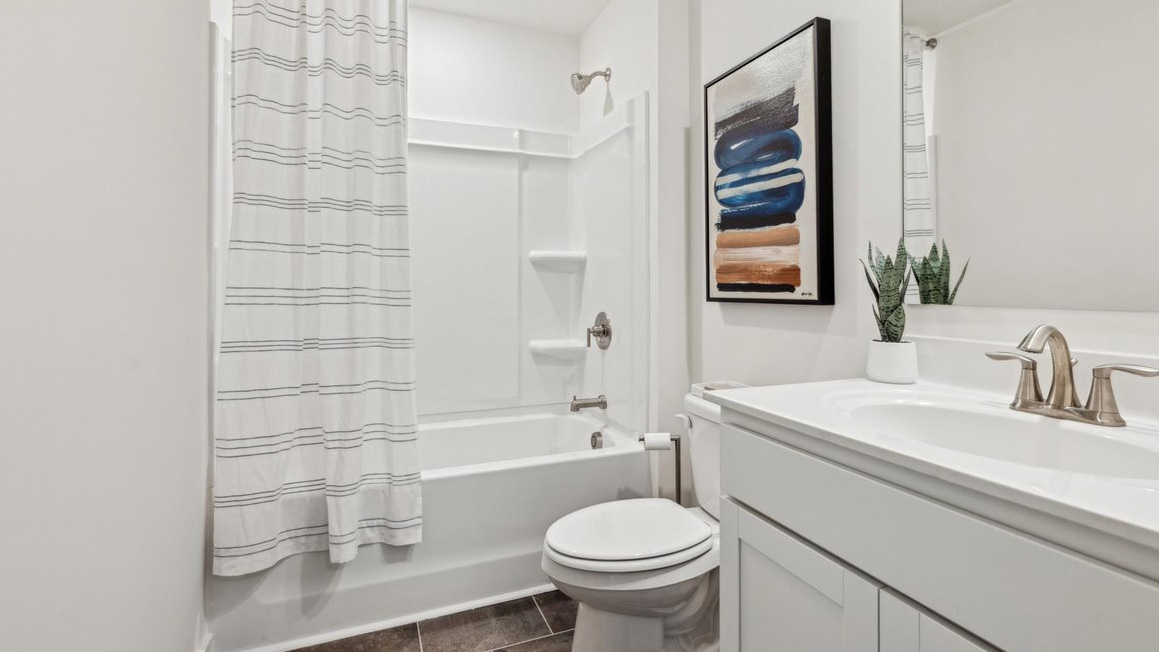 Guest bathroom with built in vanity and combination bathtub shower