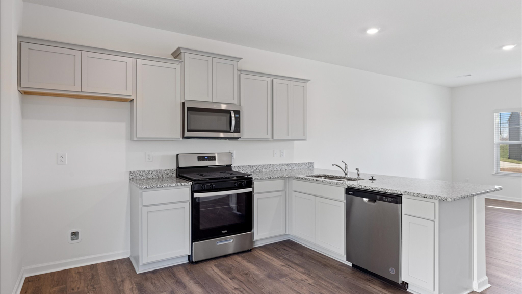 Kitchen with stainless steel appliances, shaker style cabinets, and elevated finishes
