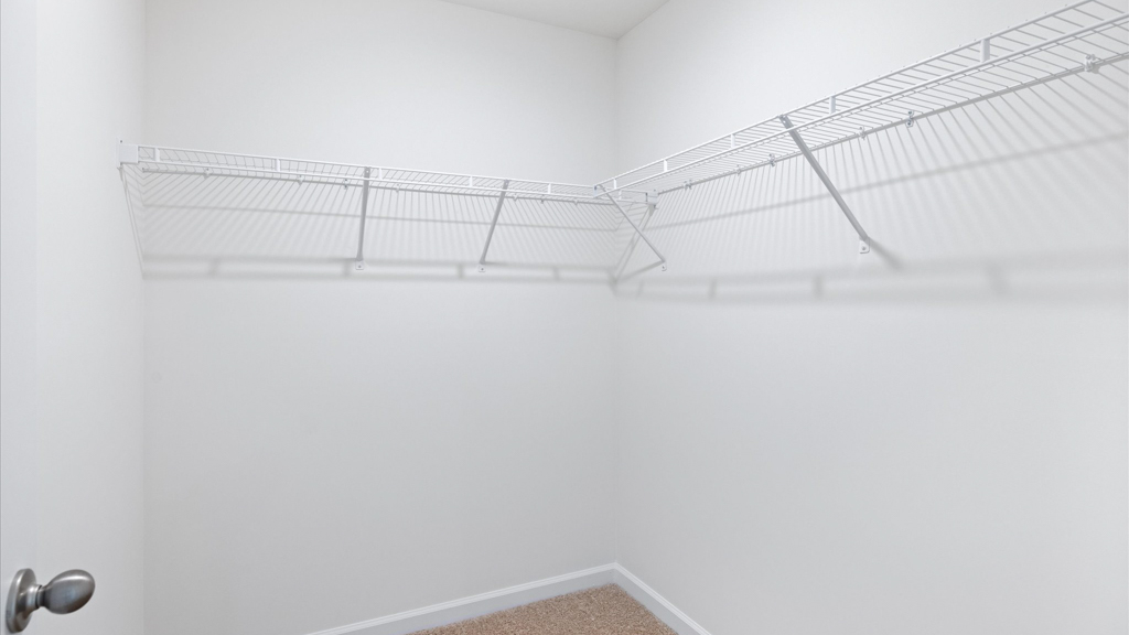 Primary bedroom with private attached bathroom and walk-in closet