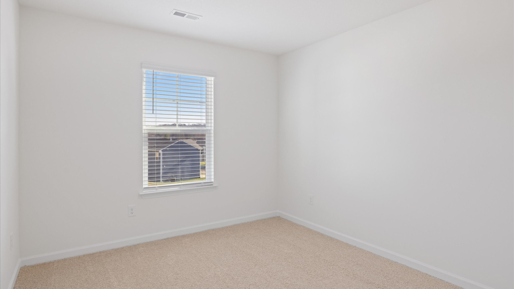 Bedroom with ample natural light and carpet floors