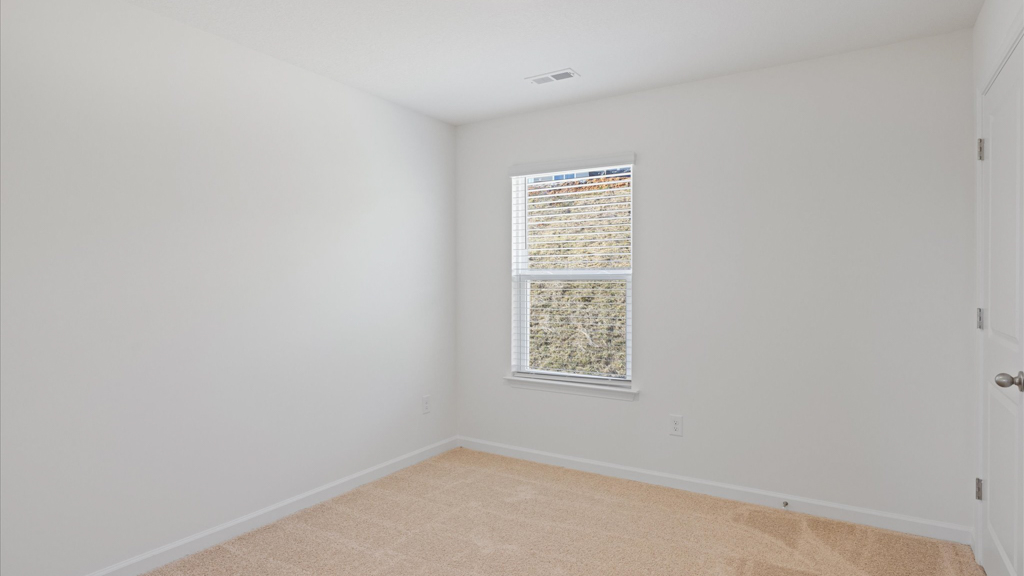 Bedroom with ample natural light and carpet floors