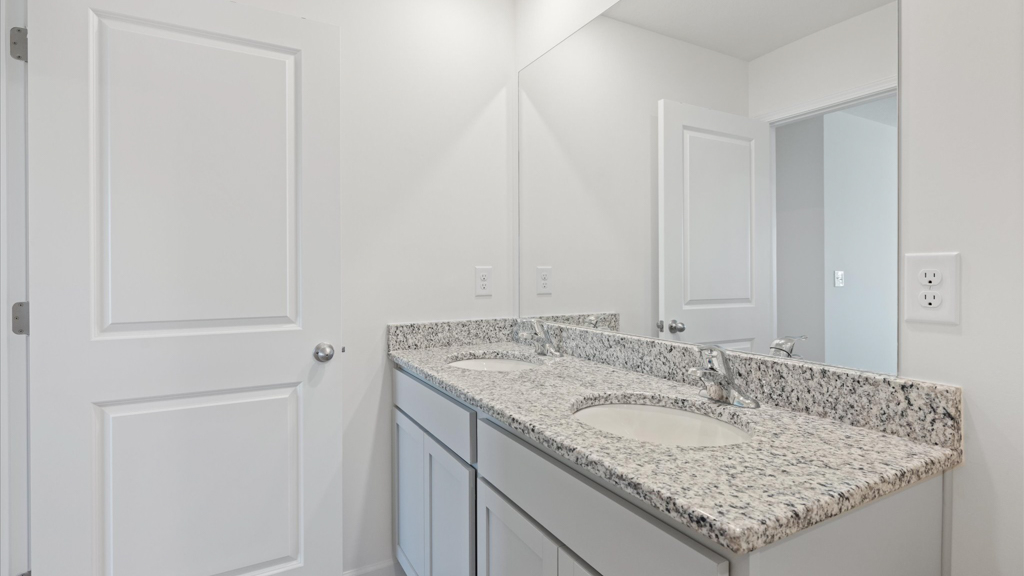 dual sink bathroom with walk in shower