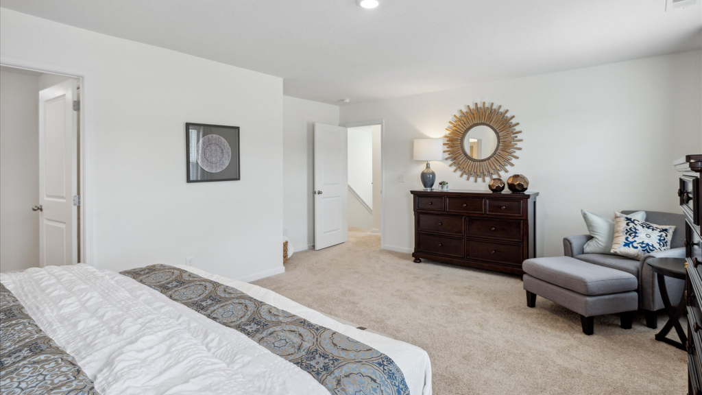 Primary bedroom with plush carpet floors and double light allowing windows