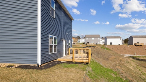 rear of two story home with deck