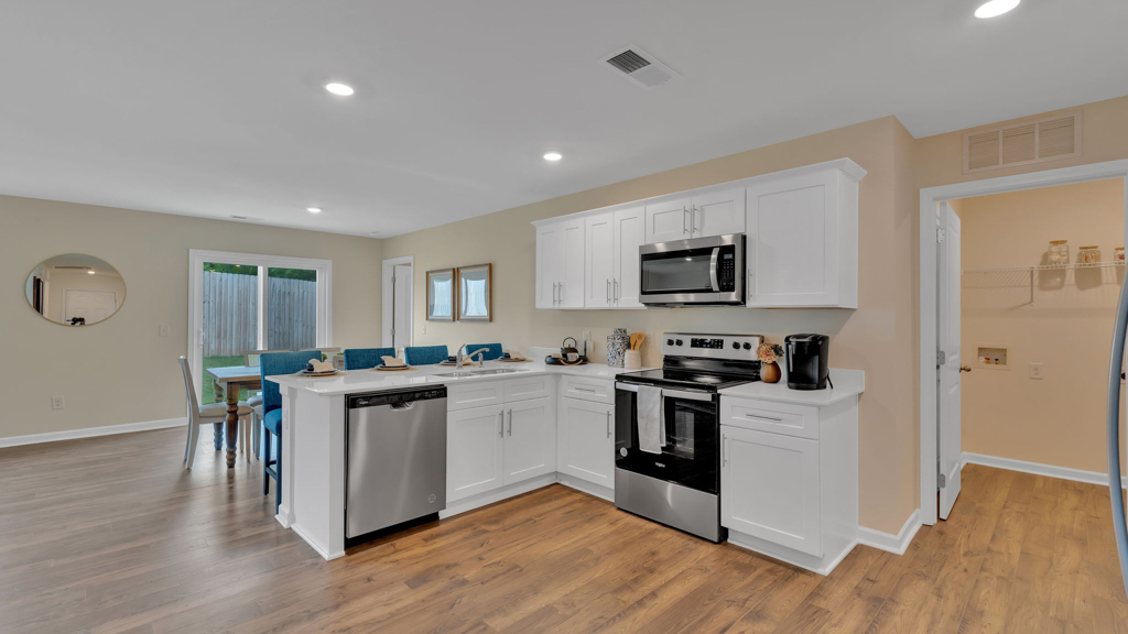 Open concept living, dining, and kitchen space