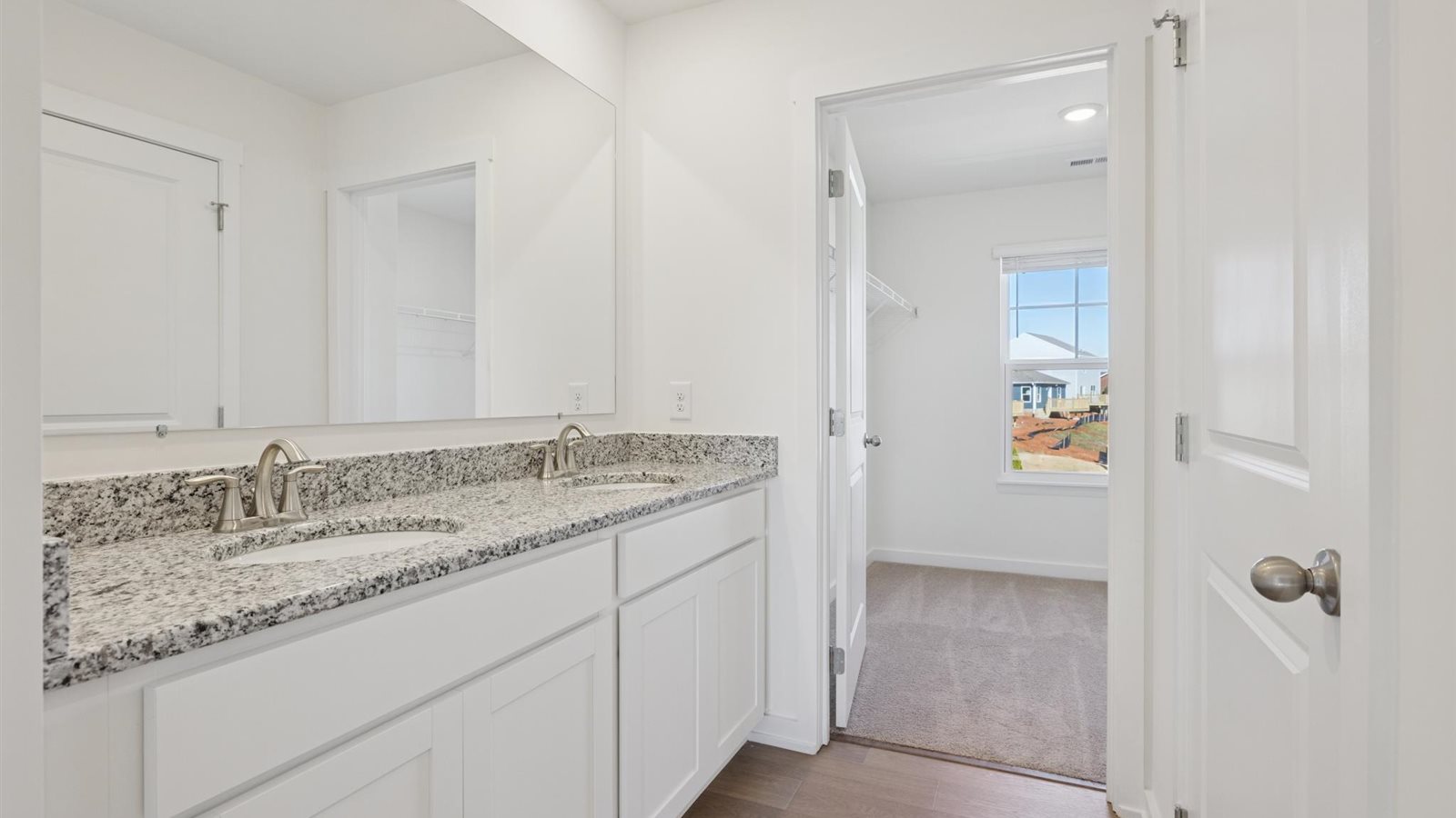 Primary bathroom with double vanity and walk-in shower