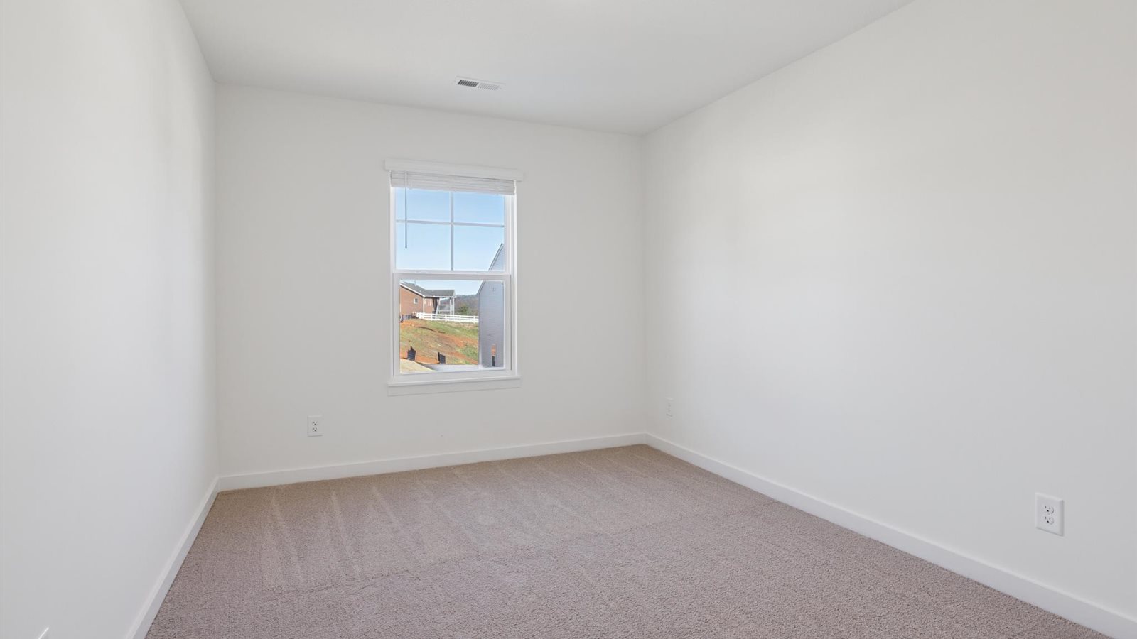 Bedroom with ample natural light and carpet floors