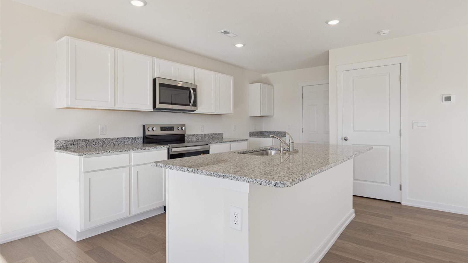 Open concept living, dining, and kitchen space