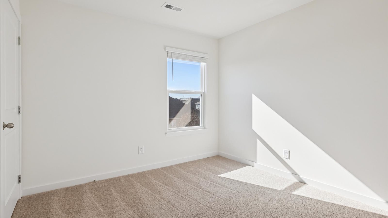Bedroom with ample natural light and carpet floors