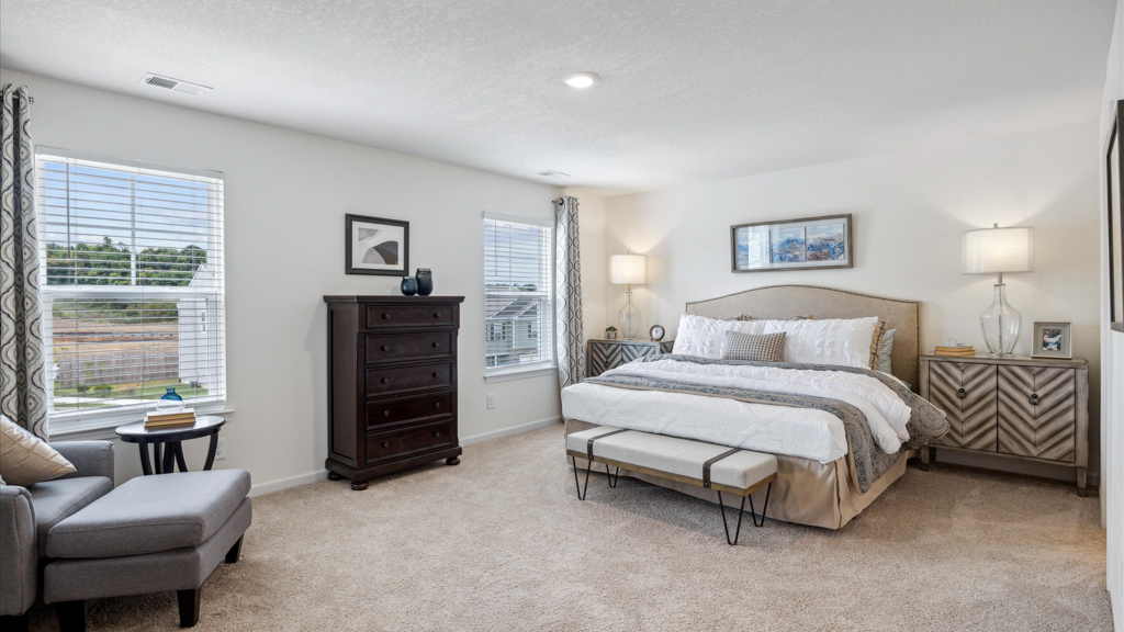 Primary bedroom with private attached bathroom and walk-in closet