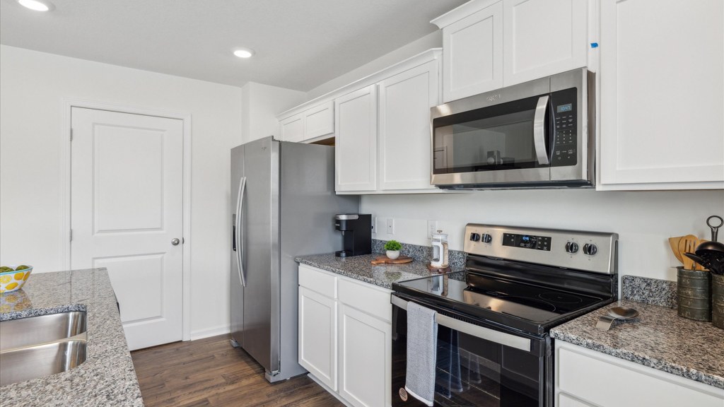 Open concept living, dining, and kitchen space