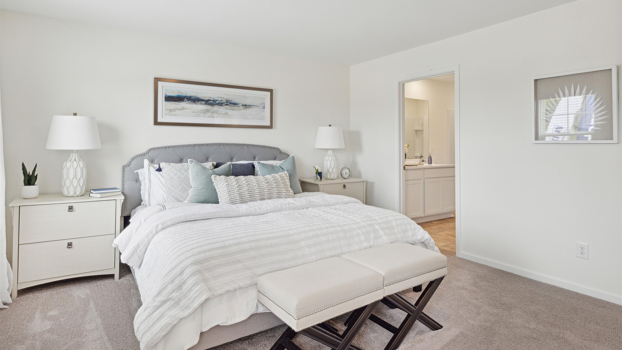 Primary bedroom with private attached bathroom and walk-in closet