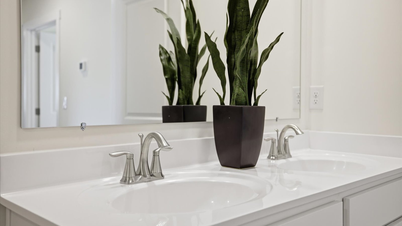 shared full bathroom with double sink vanity