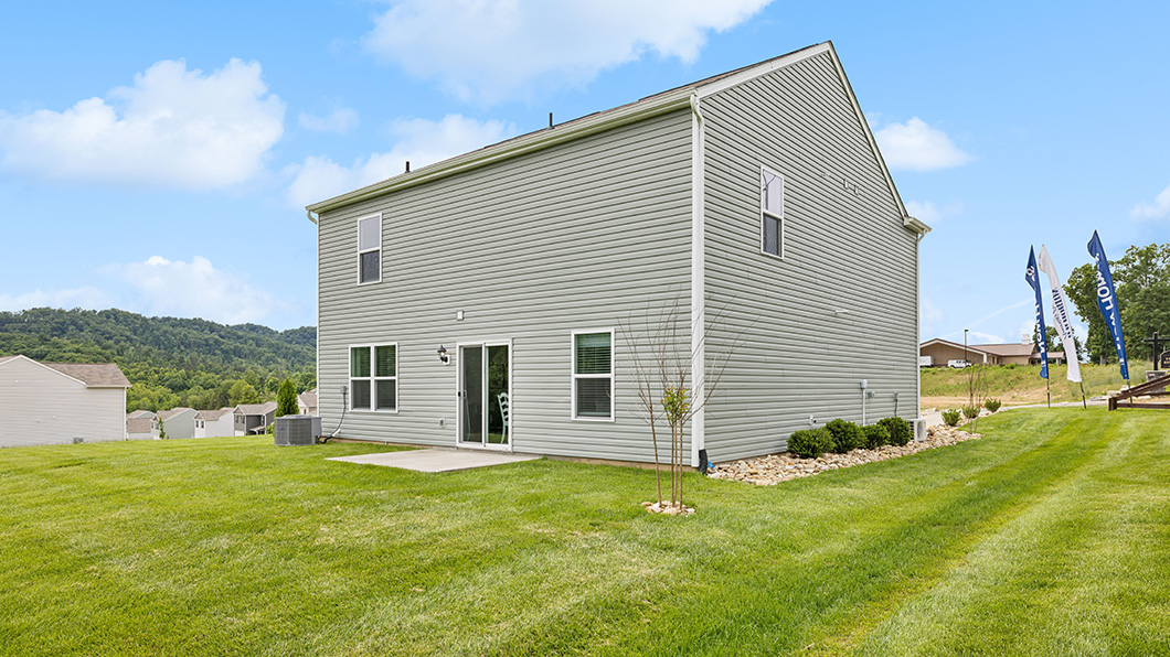 Rear exterior of home and landscaped sodded yard