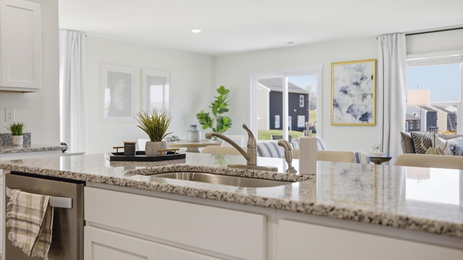 kitchen with stainless steel appliances, granite counter tops, kitchen island, and shaker style cabinets