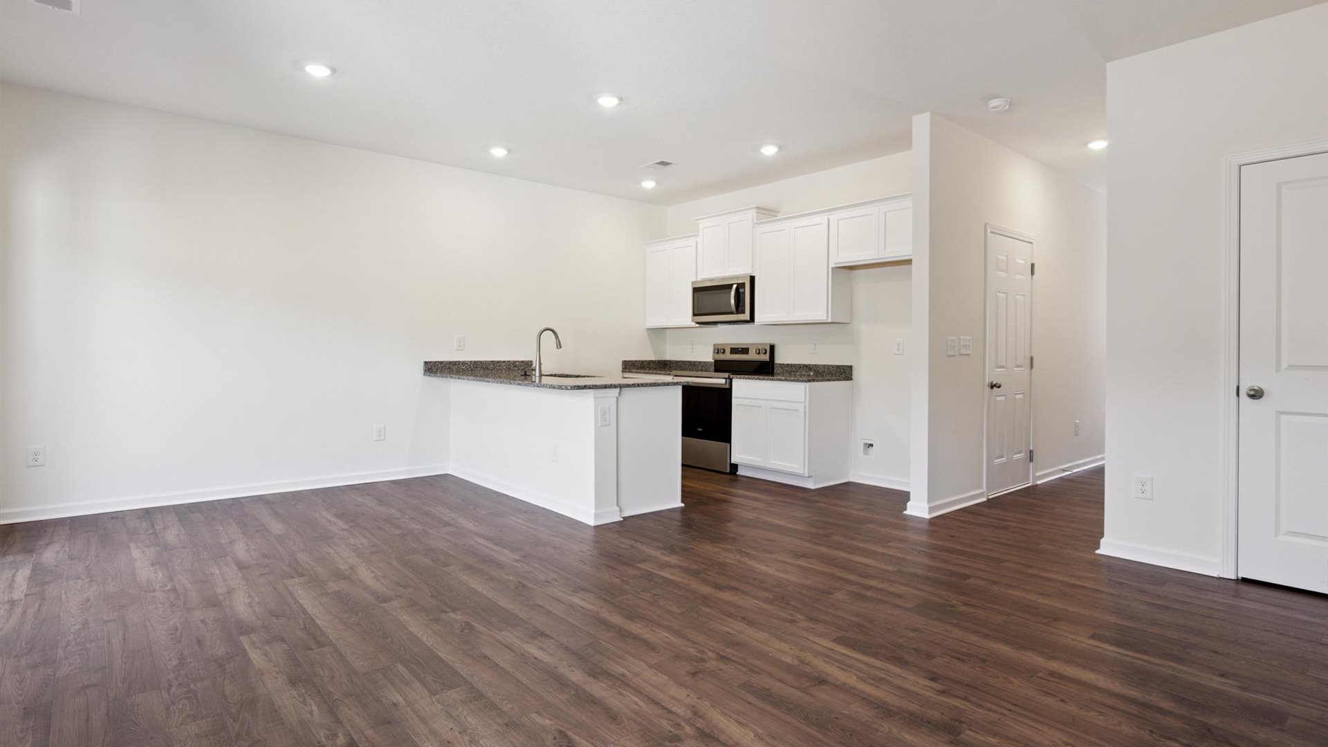 Central kitchen anchors the home adding a dining option, full sink, pantry and storage, multi-prep zones