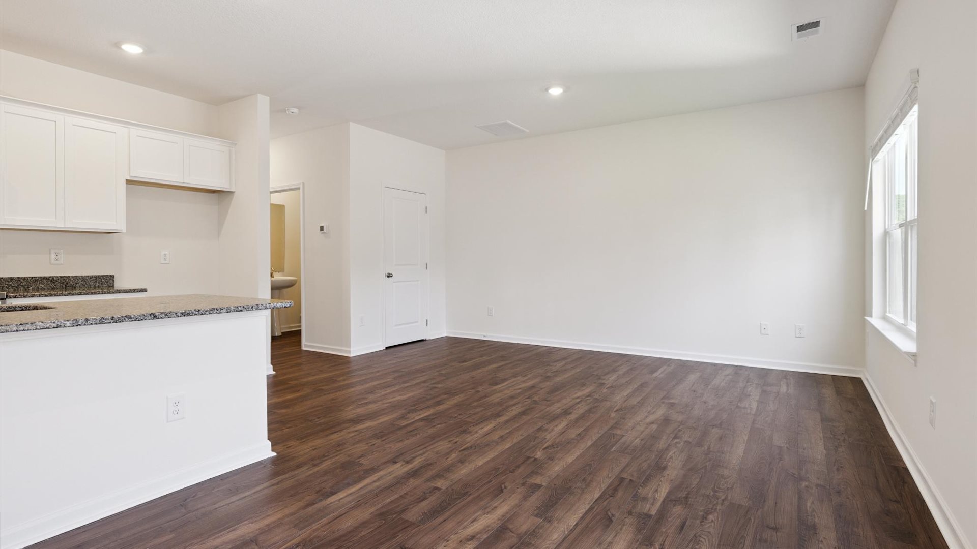 View from dining room into kitchen with island, pantry, new appliances and cabinet options at Cherokee Crossing