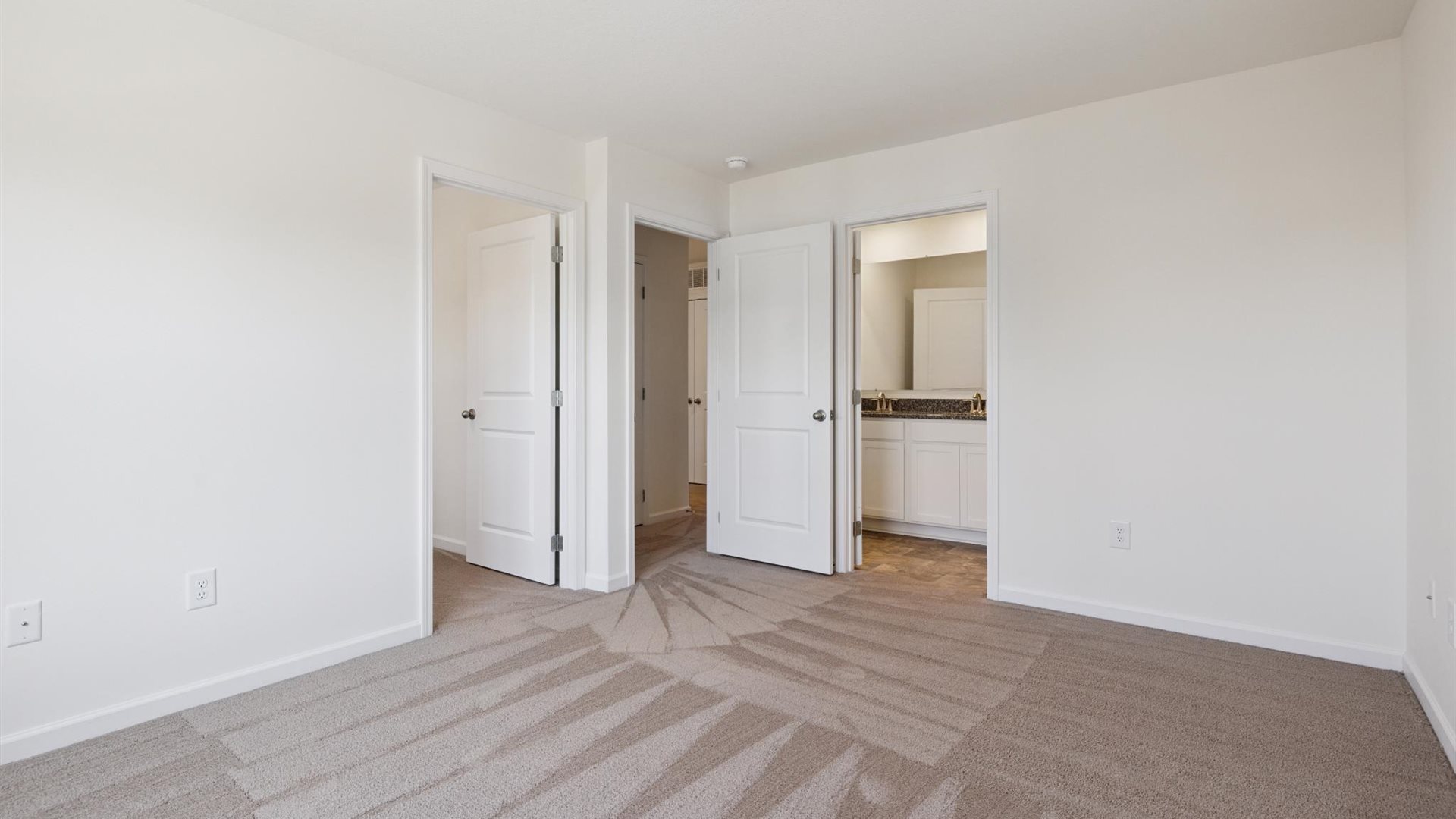 Primary bedroom in this new townhome adds space, windows, walk-in closet, and a spa-inspired ensuite bath