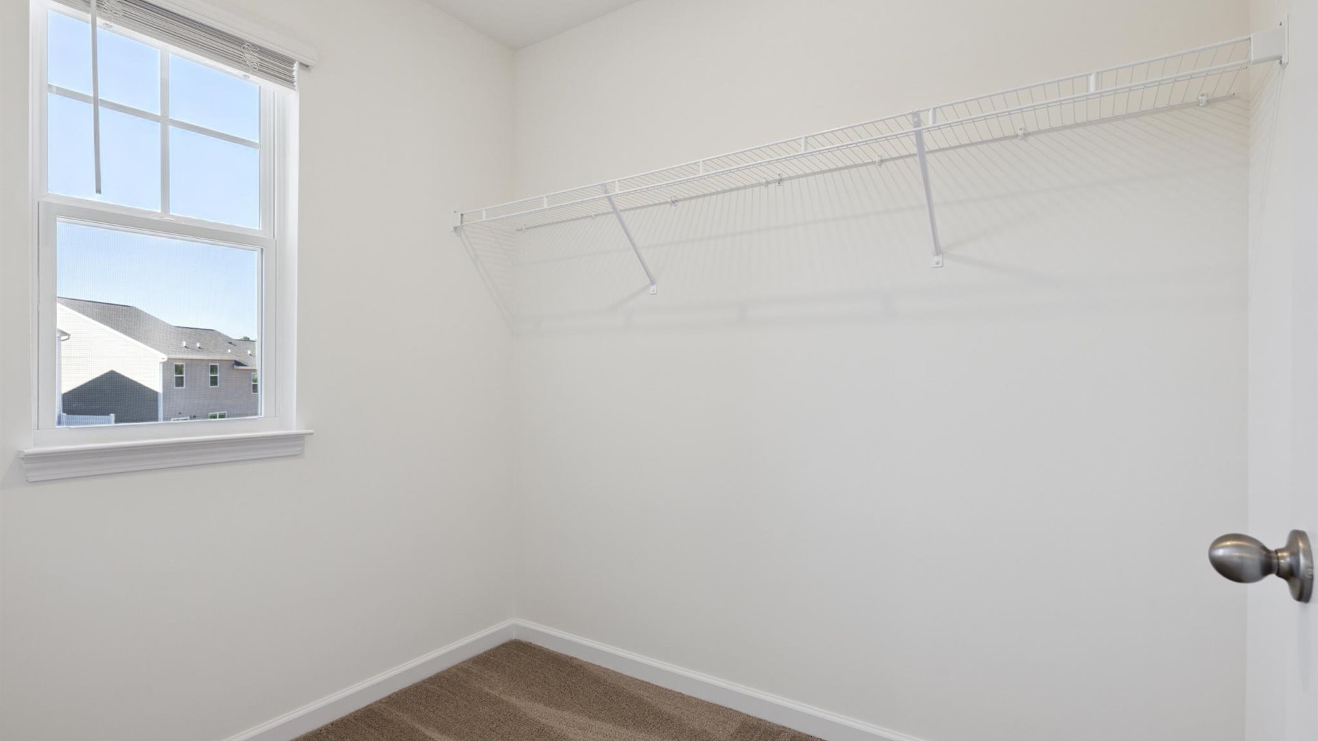 Primary suite walk-in closet in Cherokee Crossing new home with built-in shelving and generous storage