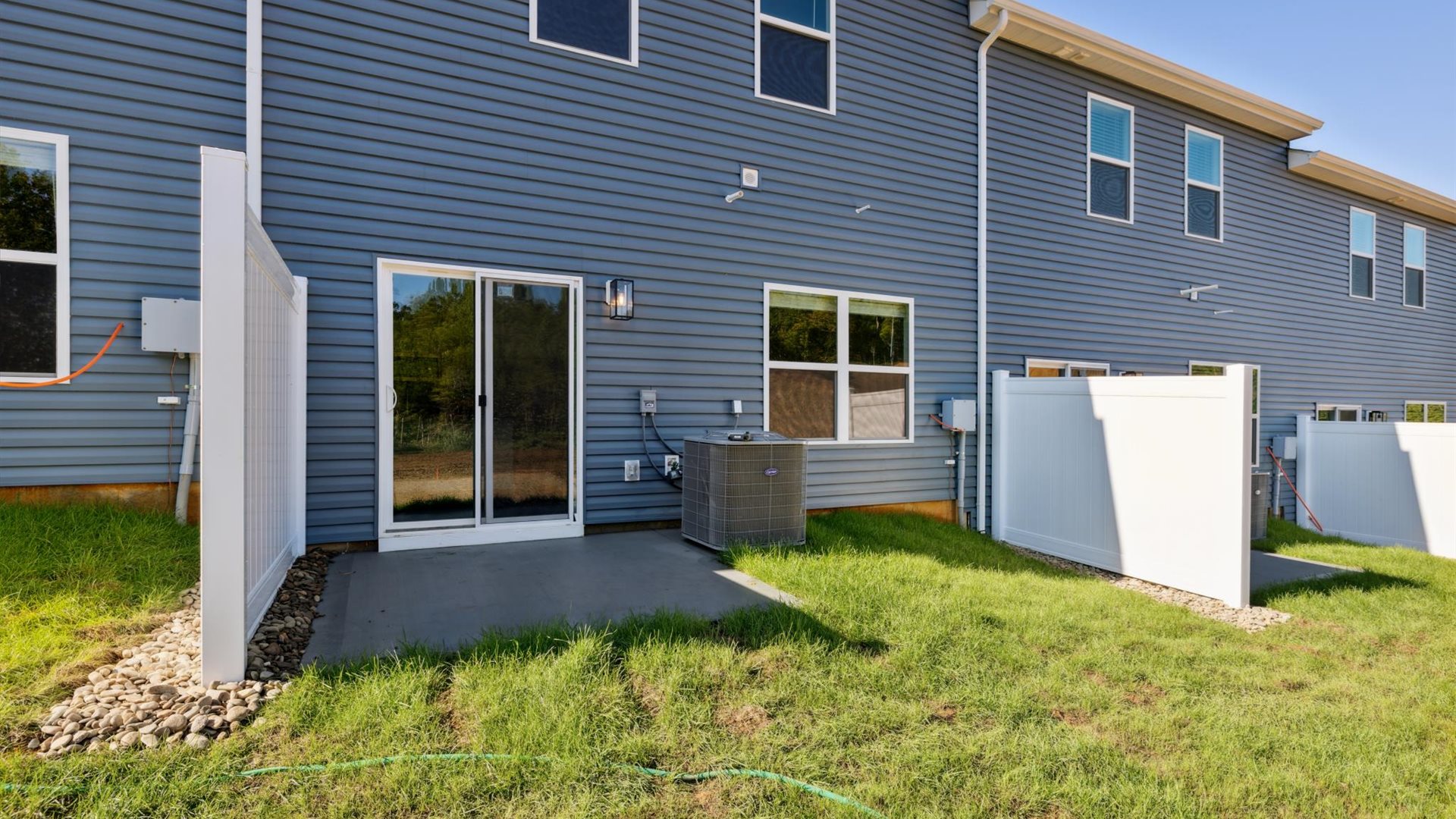 Backyards with concrete patio area offering room for seating, grill setup, and a transition from indoor to outdoor living