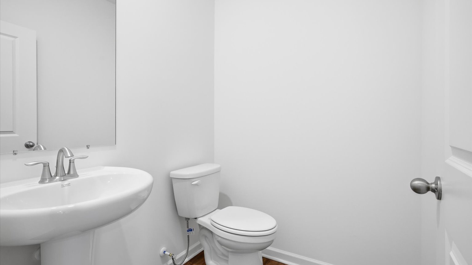 Downstairs guest half bathroom with pedestal sink