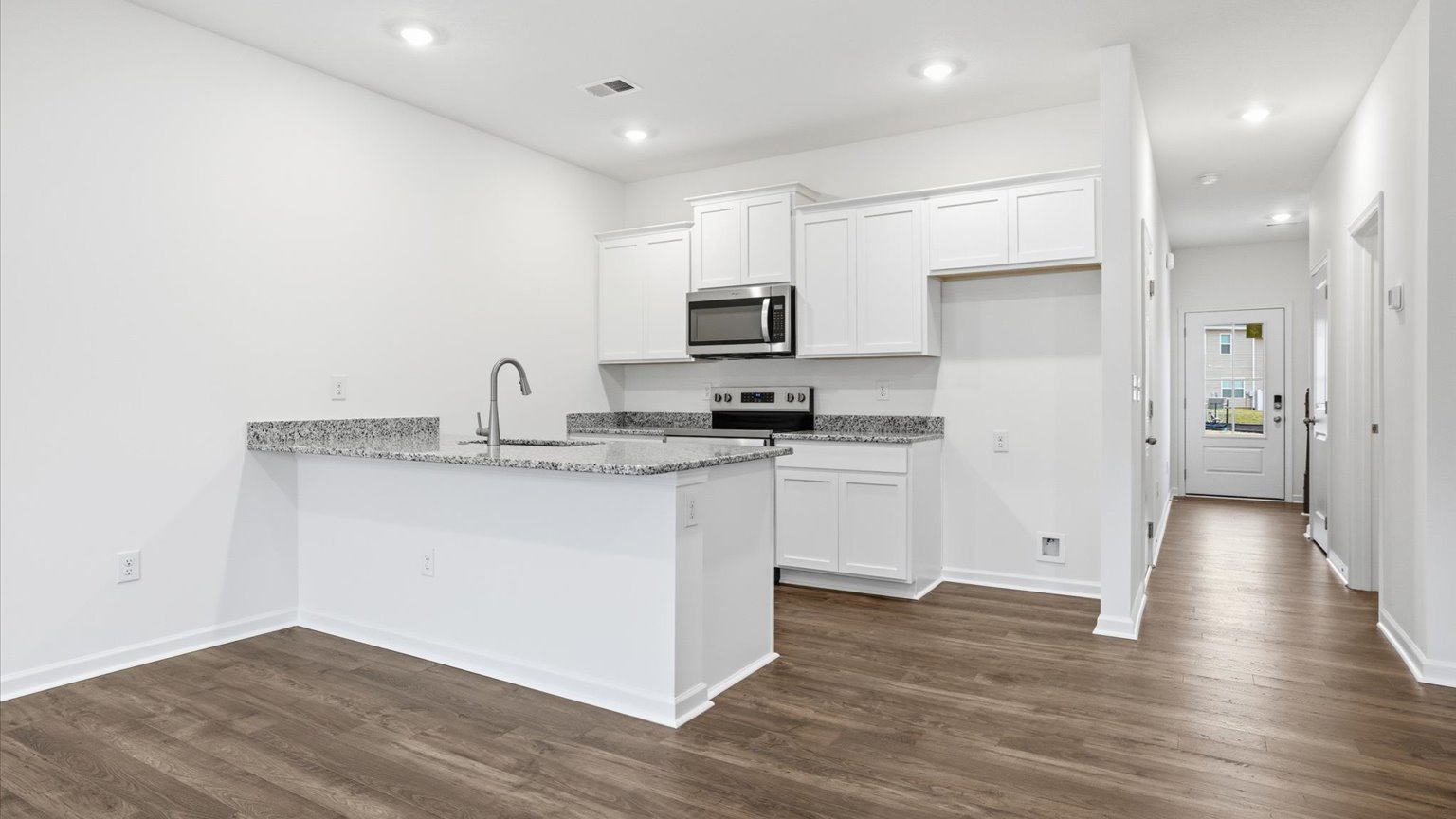 Kitchen with stainless steel appliances, shaker style cabinets, and elevated finishes