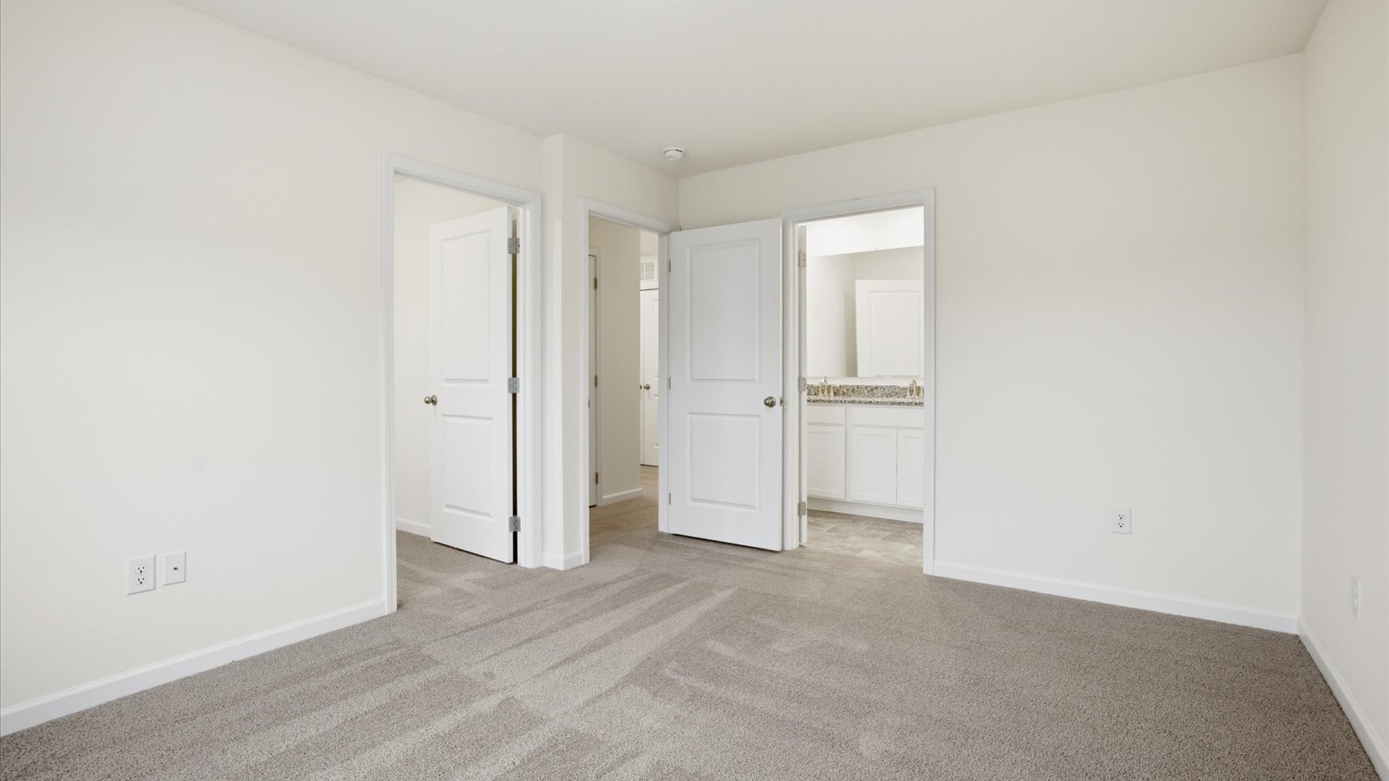 Primary bedroom with plush carpet floors and double light allowing windows