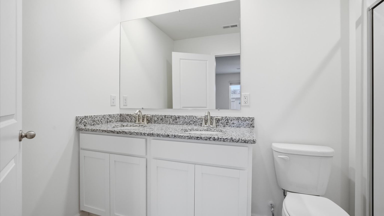 Private attached primary bathroom with built in vanity