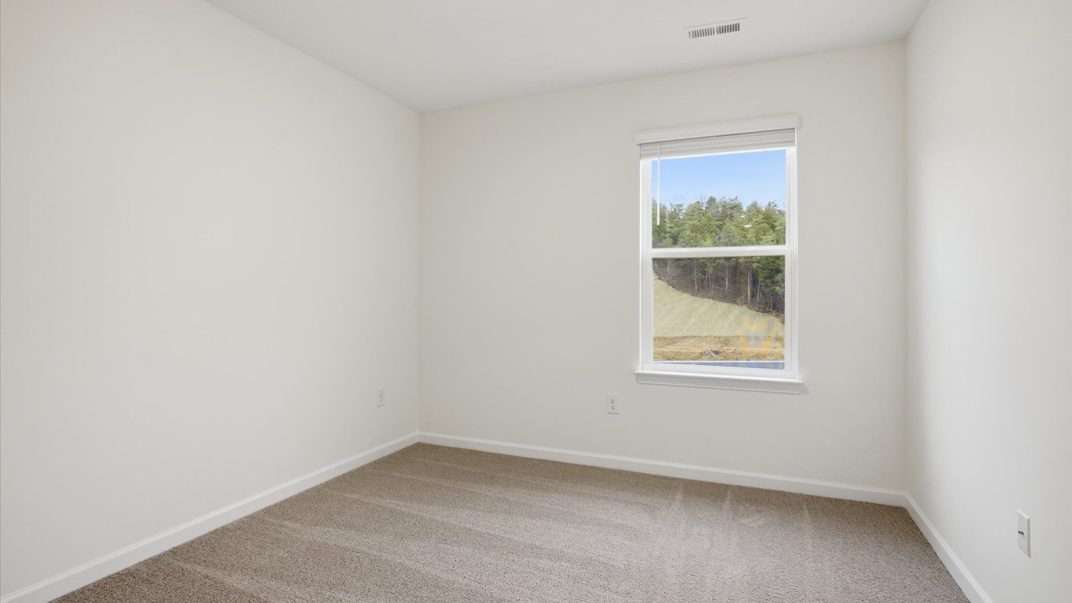 Bedroom with ample natural light and carpet floors