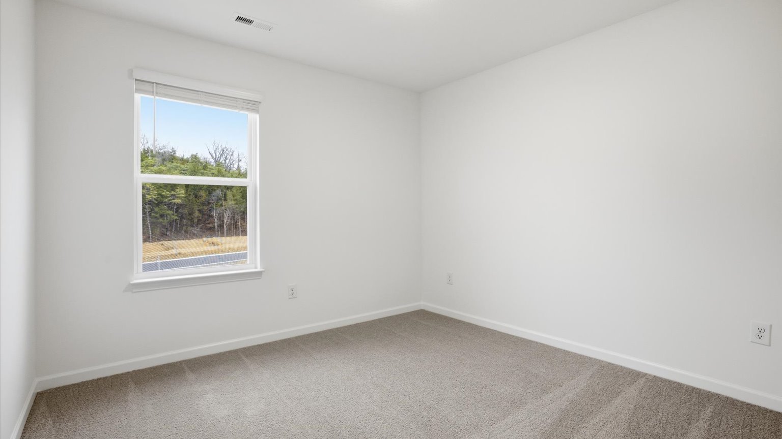 Bedroom with ample natural light and carpet floors