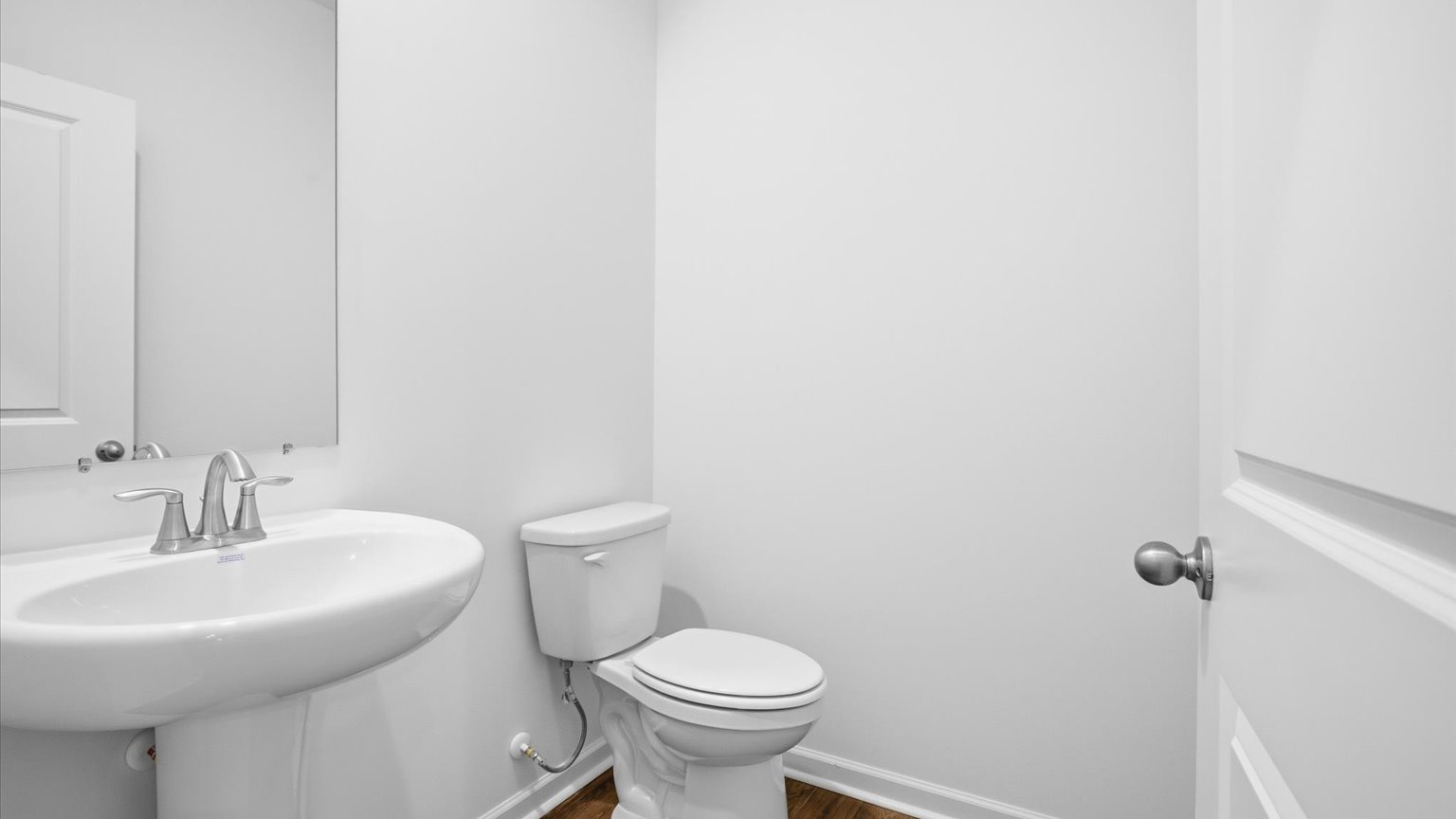 Downstairs guest half bathroom with pedestal sink