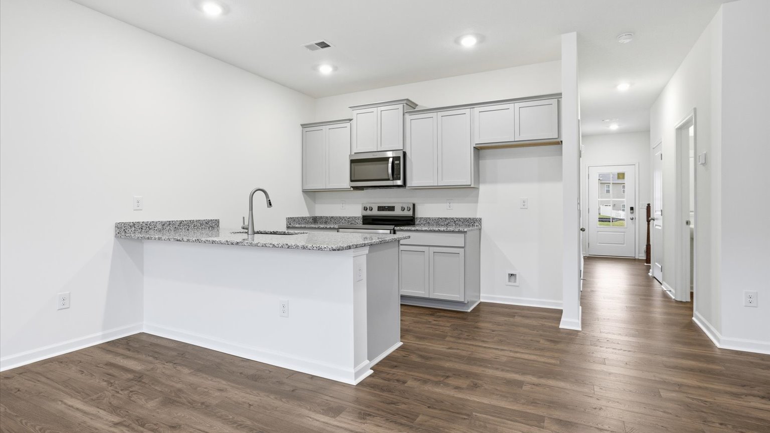 Kitchen with stainless steel appliances, shaker style cabinets, and elevated finishes