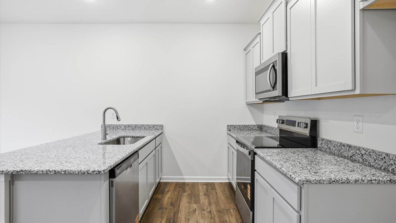 Kitchen with stainless steel appliances, shaker style cabinets, and elevated finishes