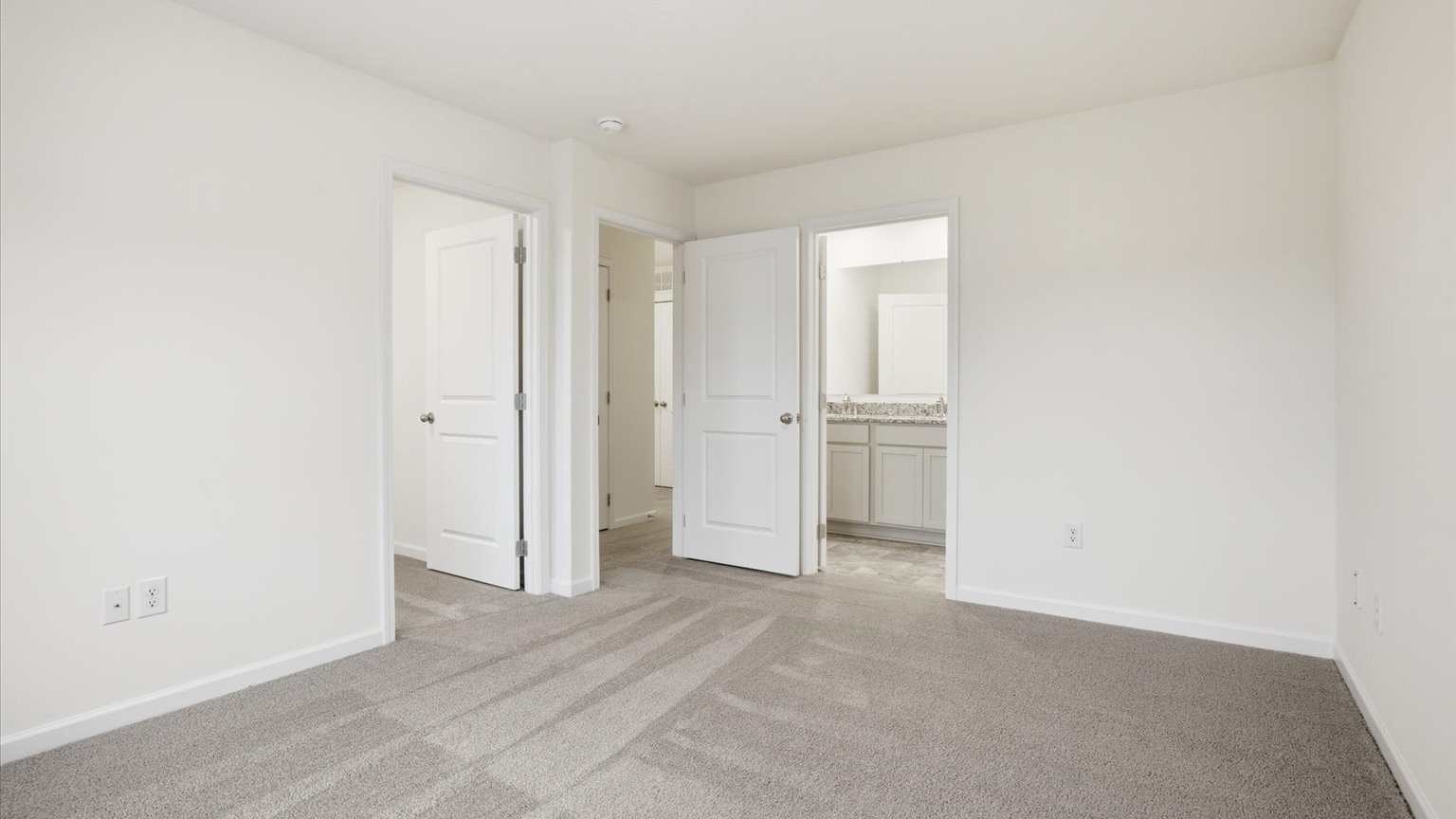 Primary bedroom with plush carpet floors and double light allowing windows