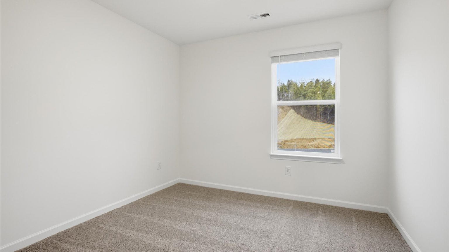 Bedroom with ample natural light and carpet floors