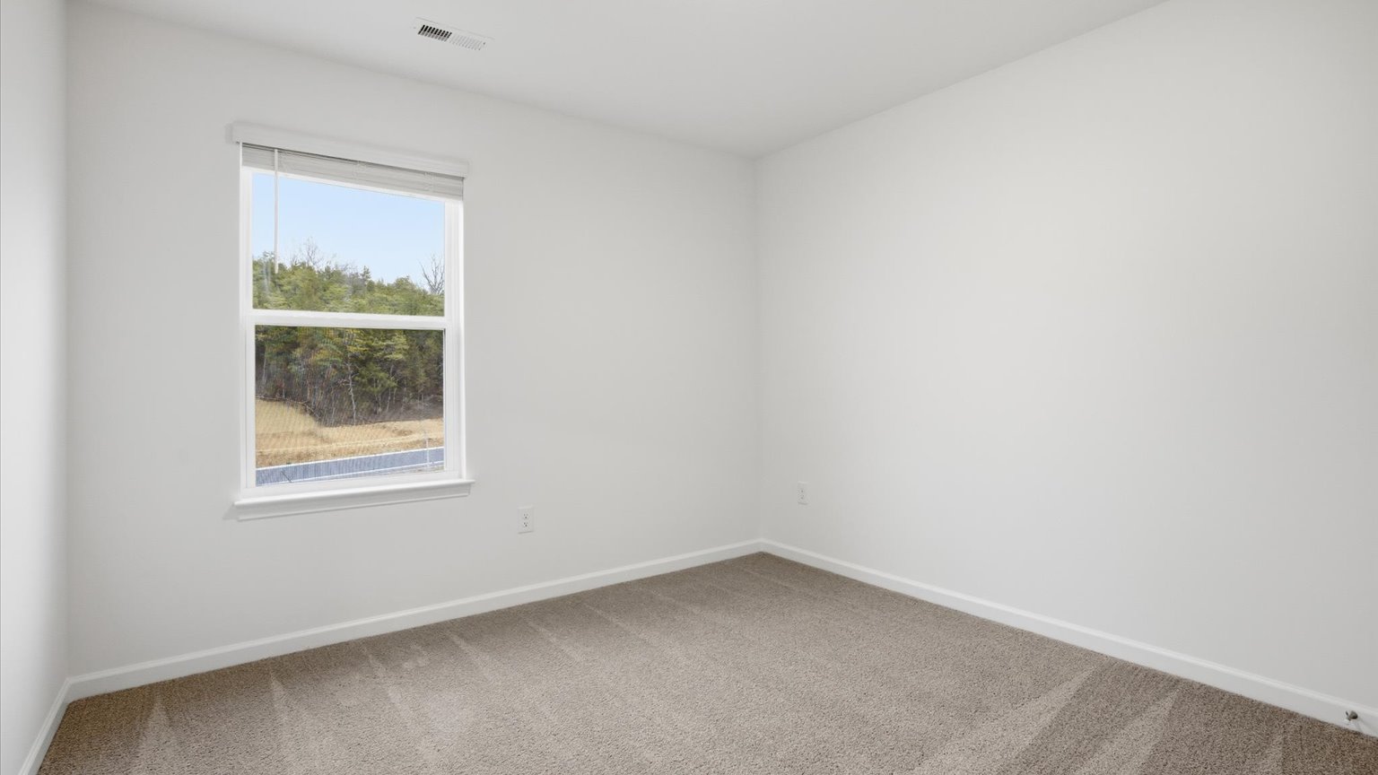 Bedroom with ample natural light and carpet floors