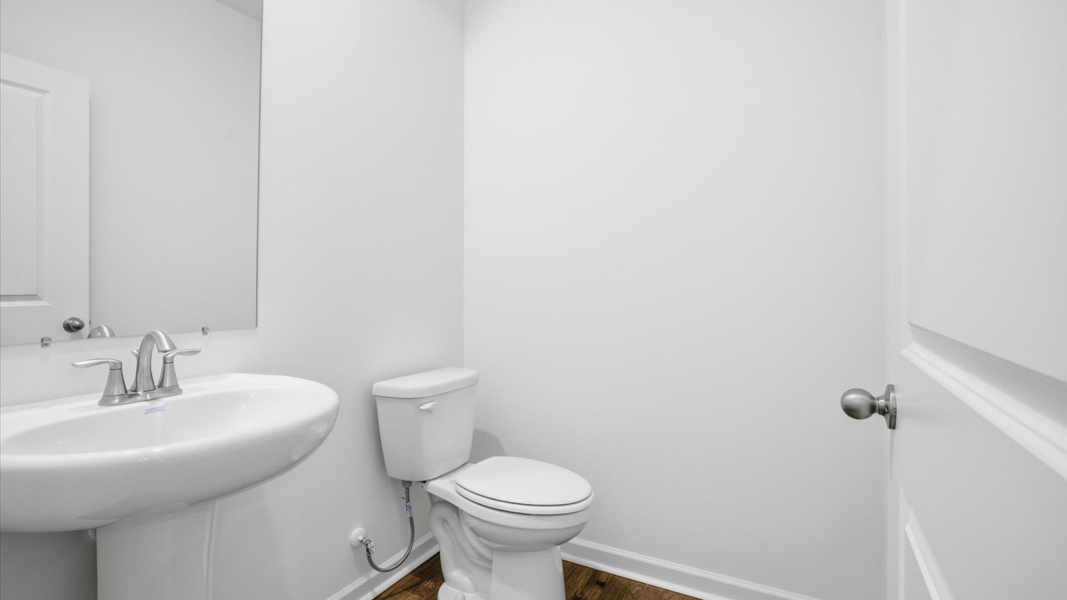 Downstairs guest half bathroom with pedestal sink