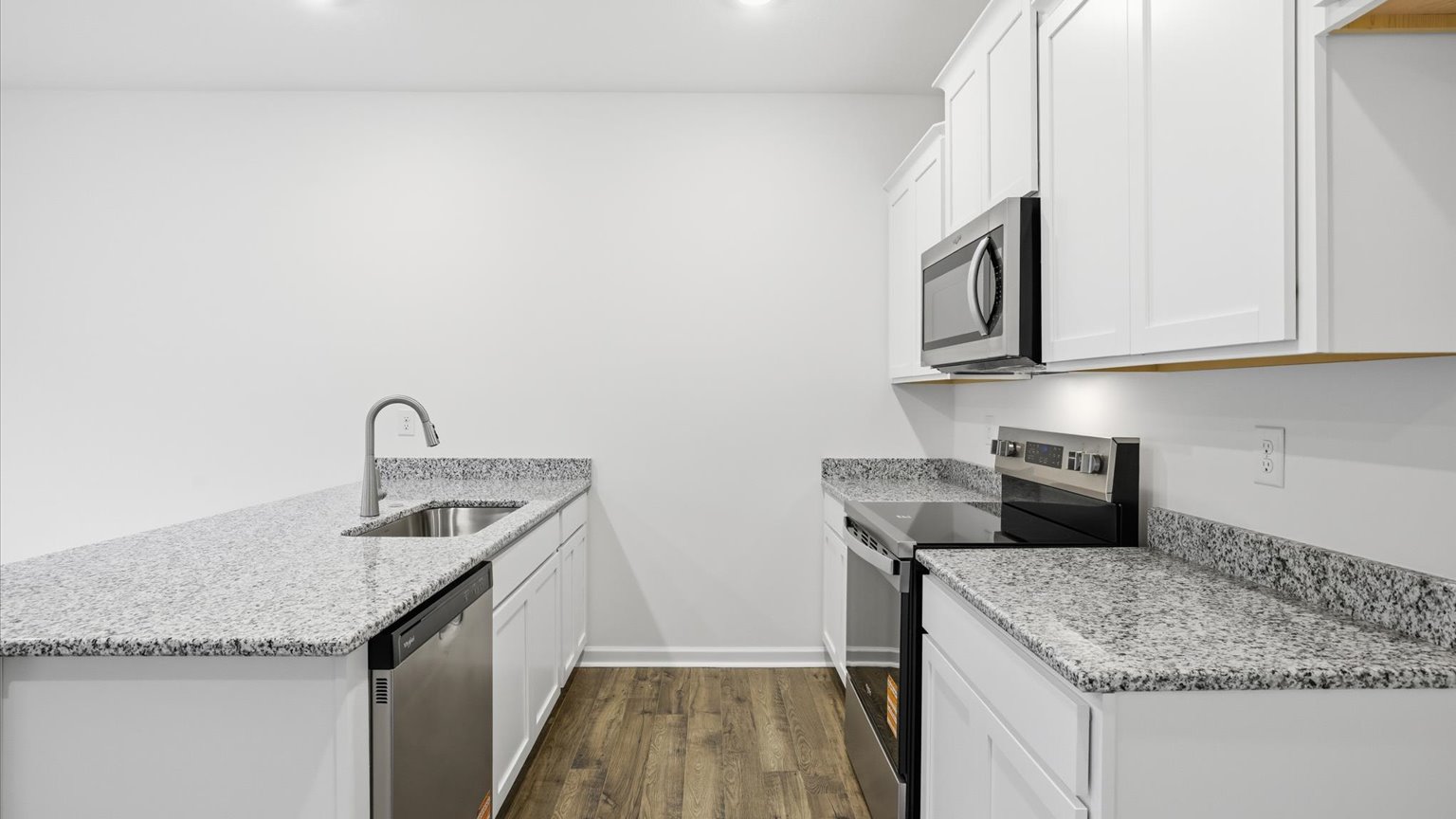 Kitchen with stainless steel appliances, shaker style cabinets, and elevated finishes