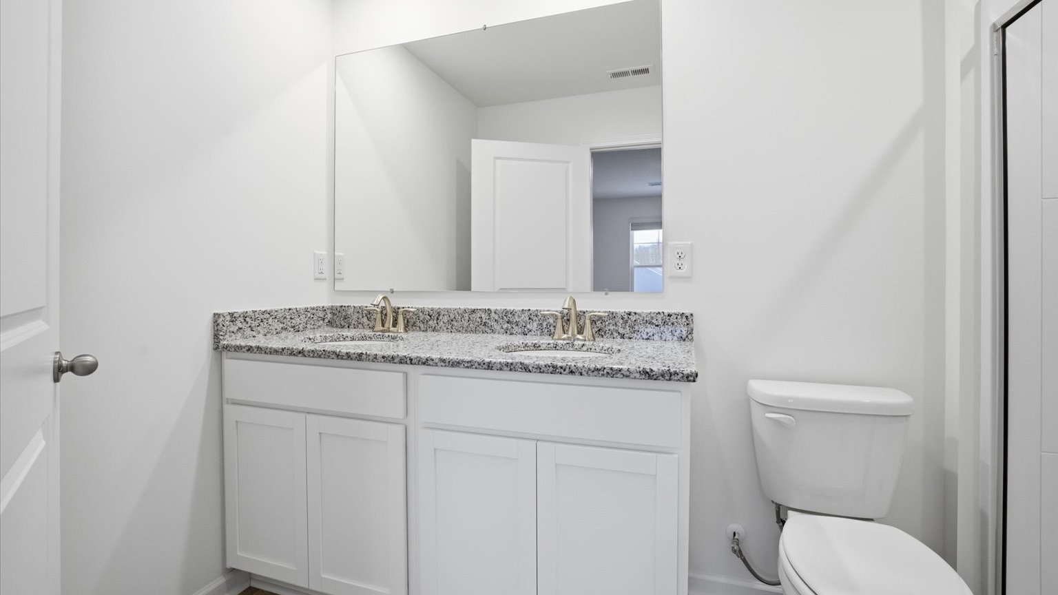 Private attached primary bathroom with built in vanity