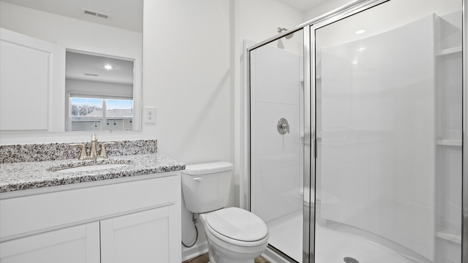 Primary bathroom with double vanity and walk-in shower