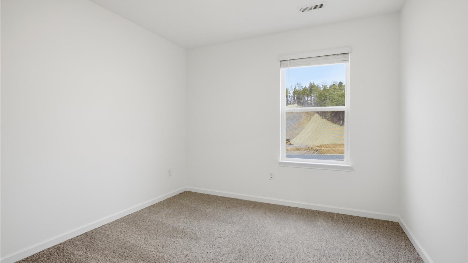 Bedroom with ample natural light and carpet floors