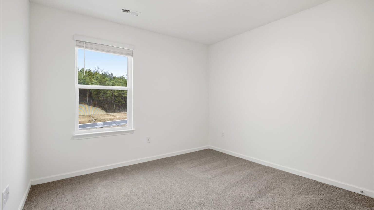 Bedroom with ample natural light and carpet floors