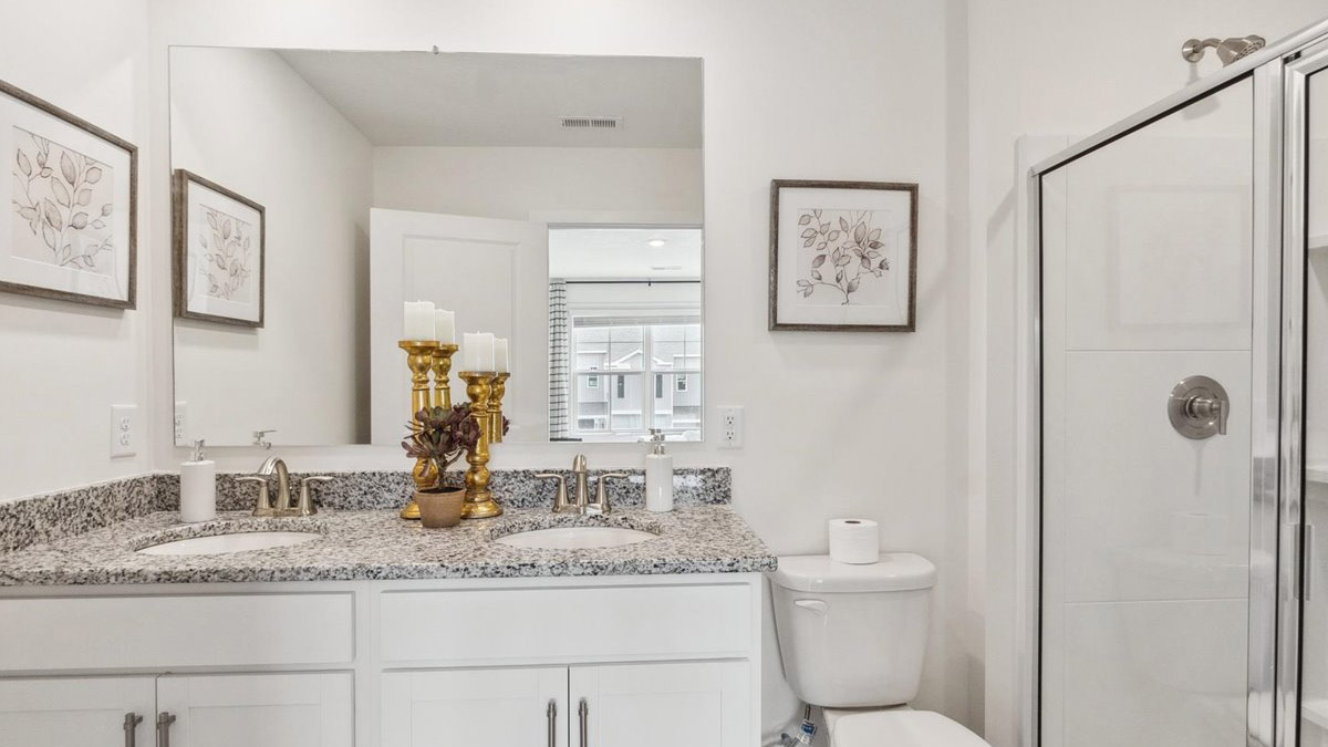 Primary bathroom with built in vanity and luxurious shower