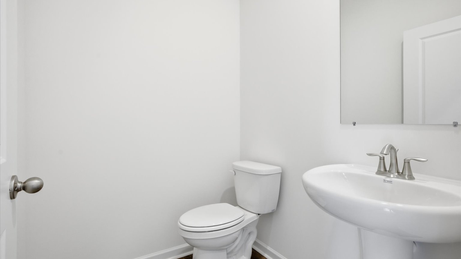 Downstairs guest half bathroom with pedestal sink