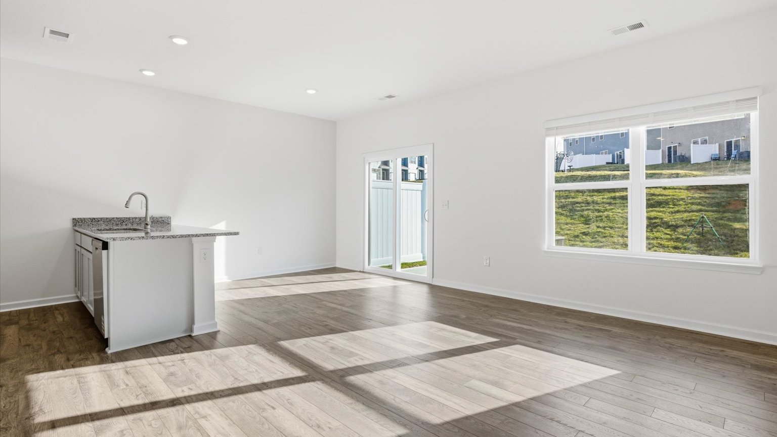 Spacious living and great  room space with light allowing windows