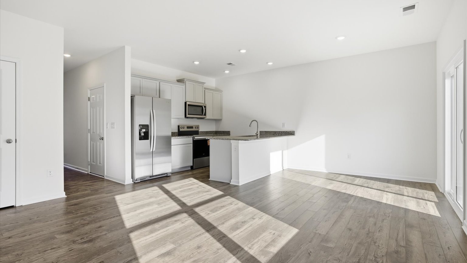 Spacious living and great  room space with light allowing windows