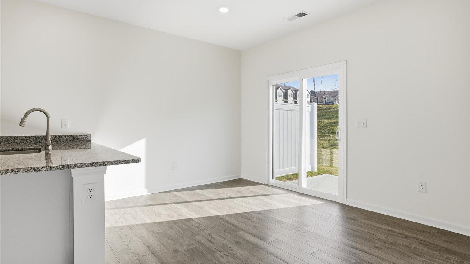 Spacious living and great  room space with light allowing windows