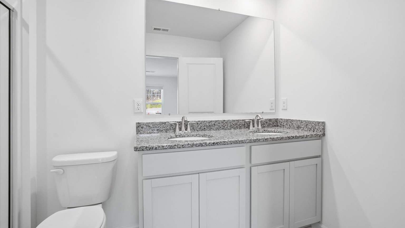 Primary bathroom with double vanity and walk-in shower